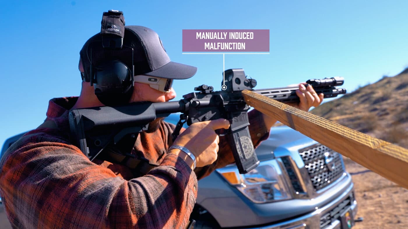 Man manually causing a rifle malfunction