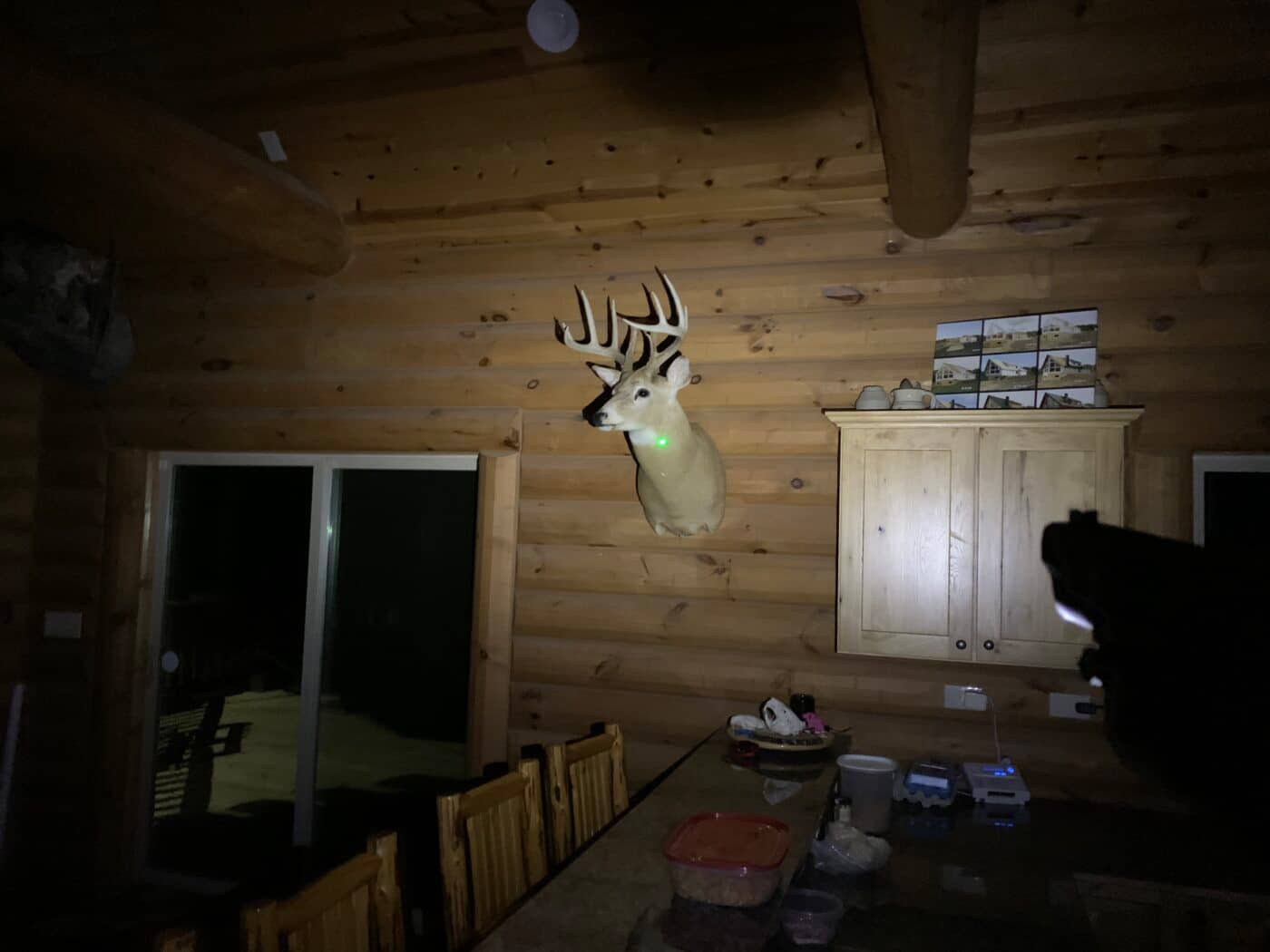 Demonstration of visibility of green laser indoors at night when using Viridian C5L on a pistol