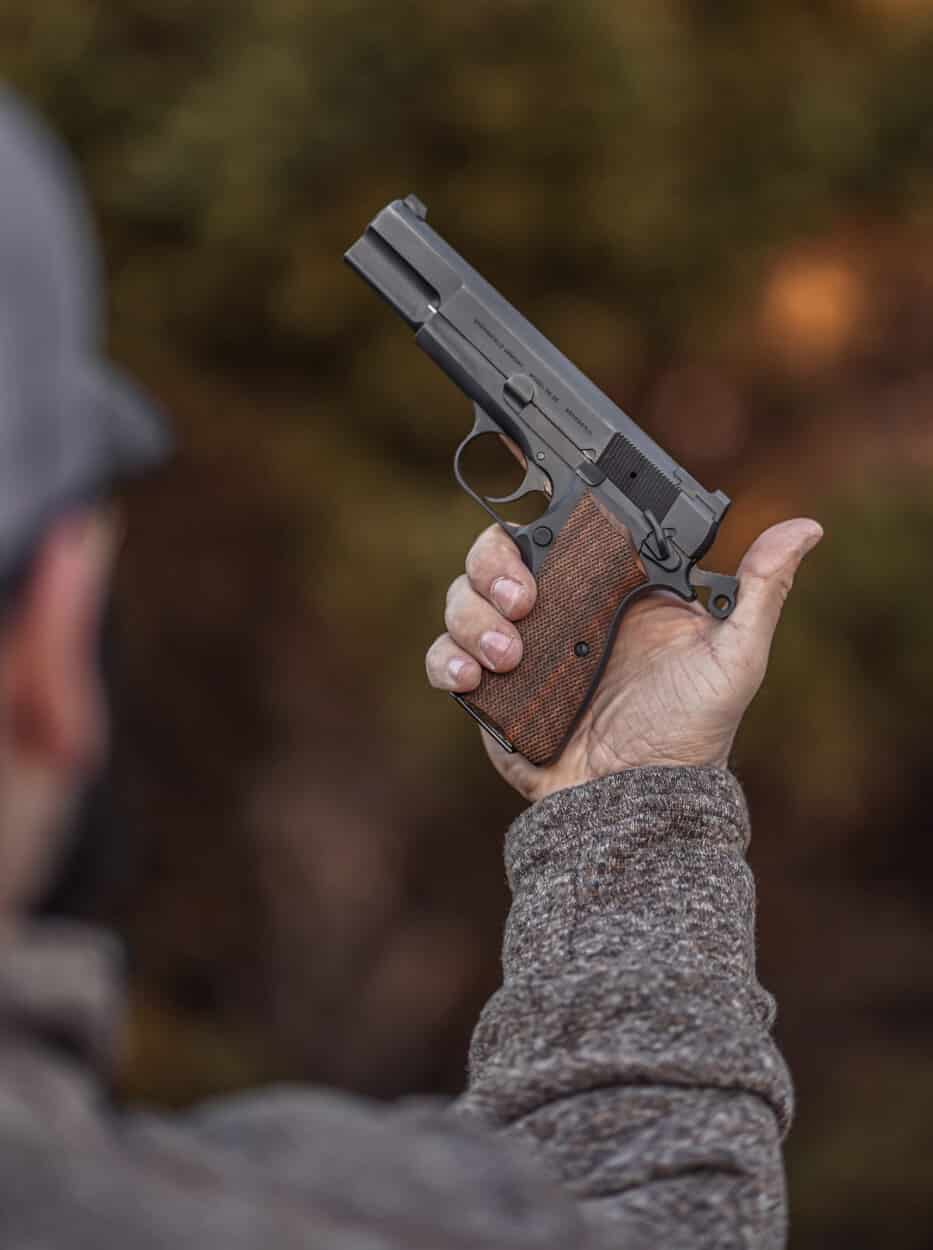 man holding the Springfield Armory SA-35 pistol