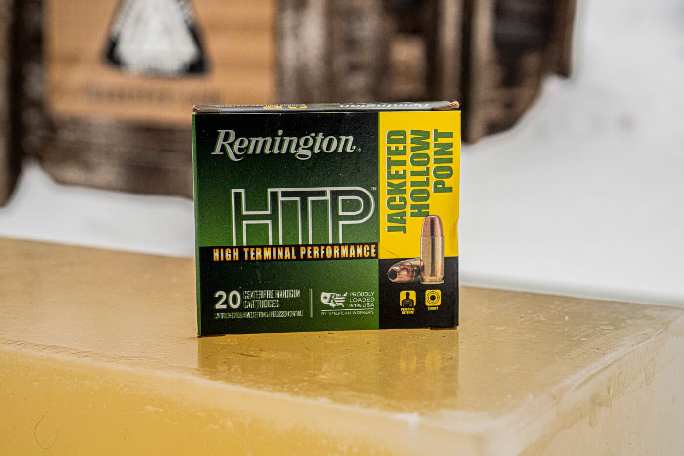 Box of Remington HTP ammo sitting on top of block of ballistic gel