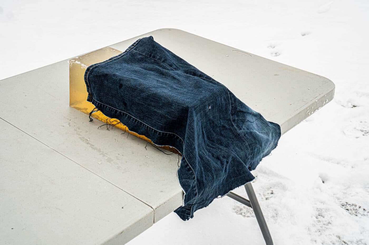 Denim draped over block of ballistic gel