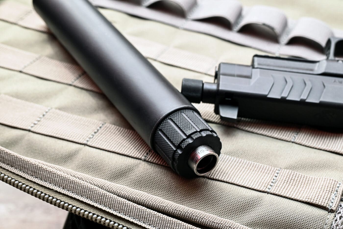 GSL noise suppressor next to threaded barrel of a Springfield XD-M Elite pistol