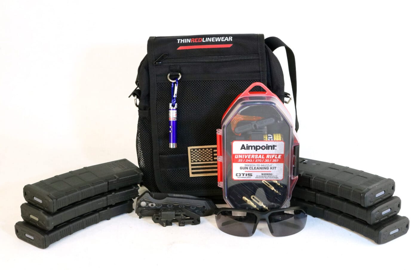 Thin Red Line Wear Operator Bag with ammo, magazines, knife, glasses, and rifle cleaning kit next to it