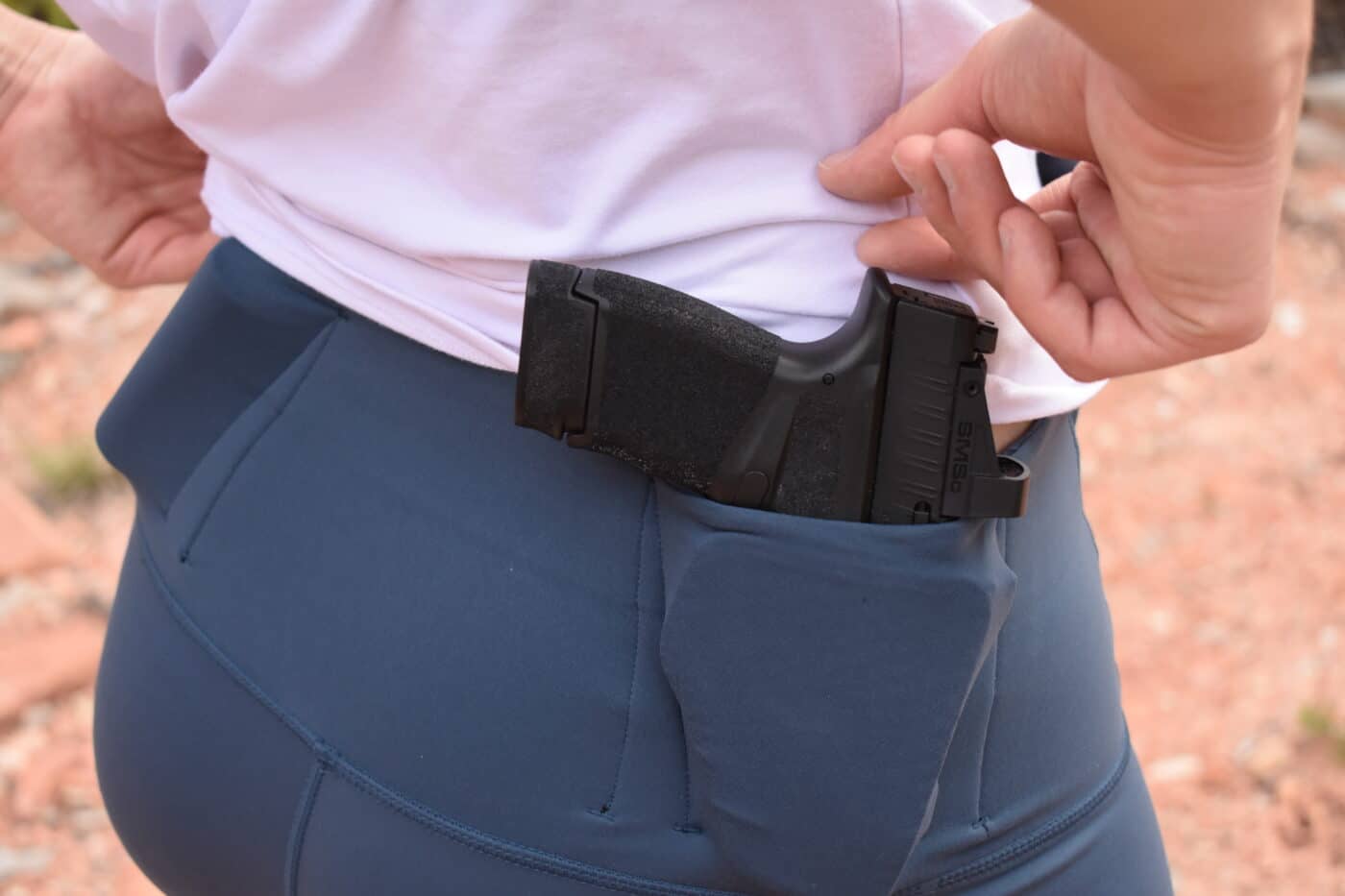 Hellcat pistol carried in women's leggings