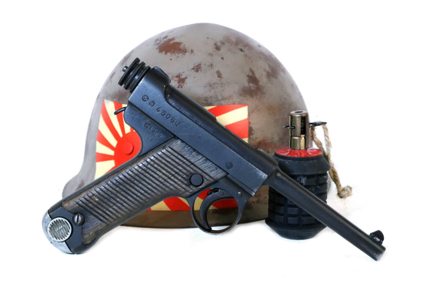 Nambu Type 14 handgun with Japanese helmet and grenade