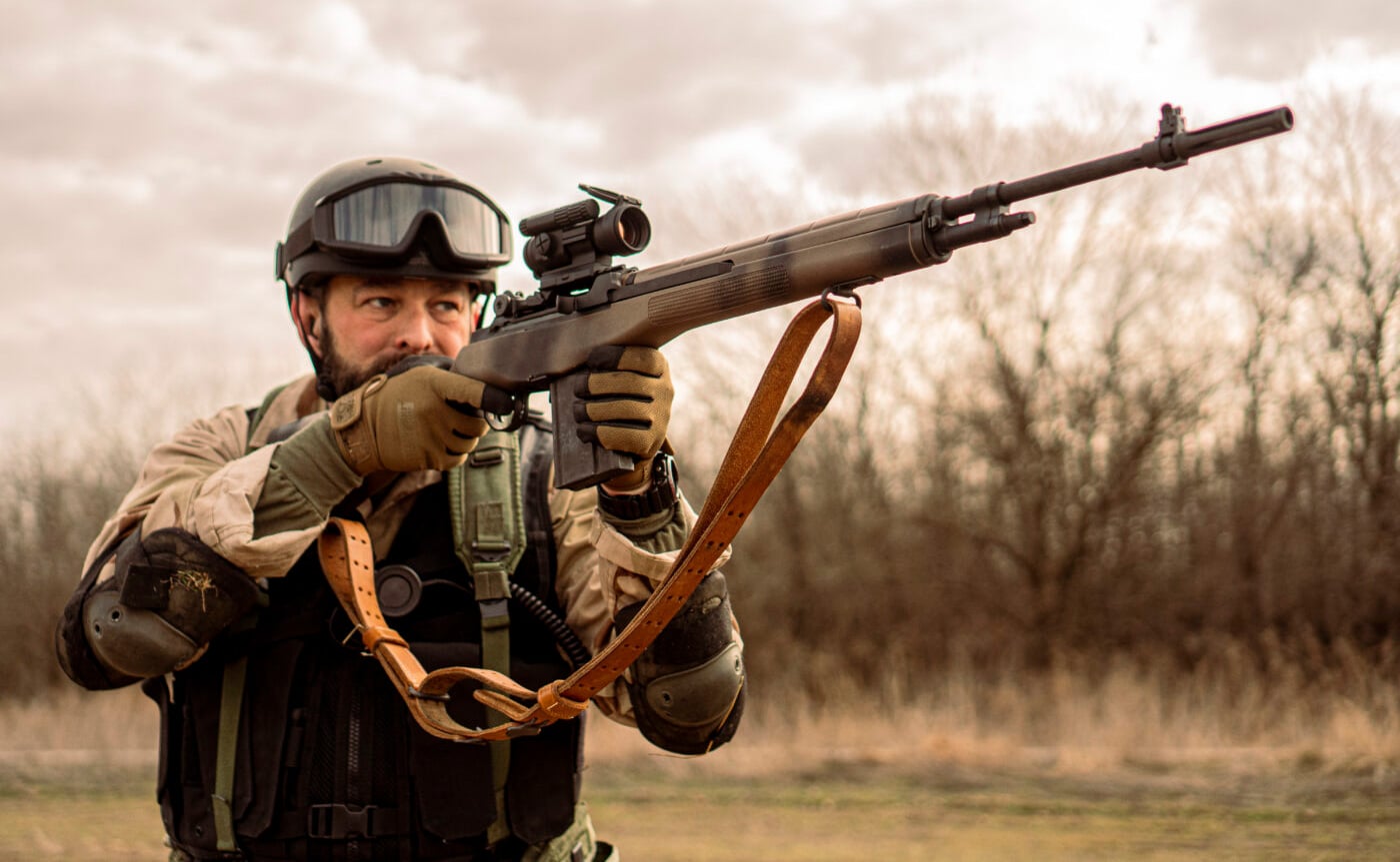 Man shooting customized Springfield M1A rifle