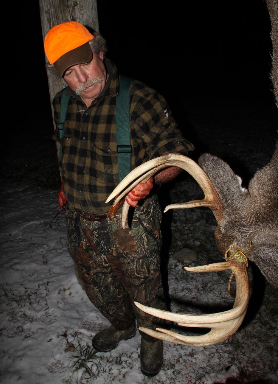 hunter with buck