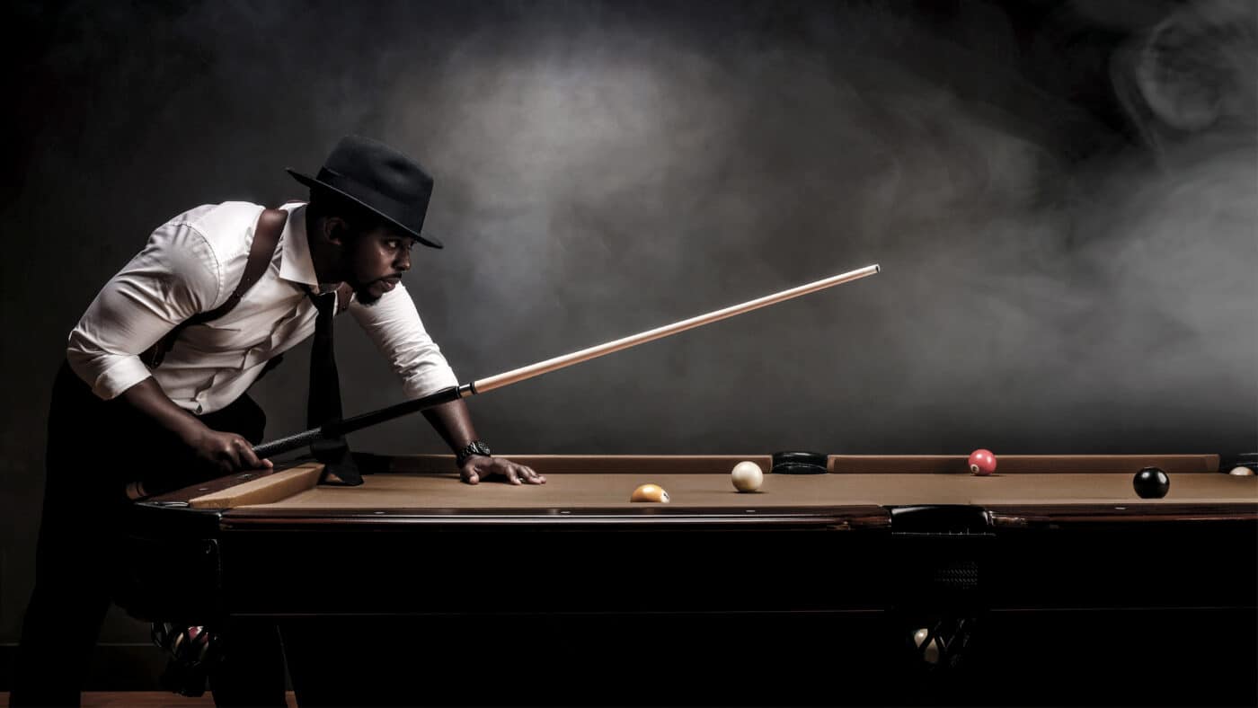Colion Noir plays billiards while carrying a Springfield Armory SA-35