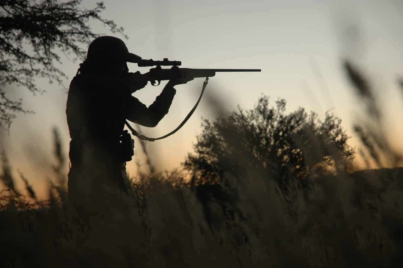 hunter shooting rifle offhand