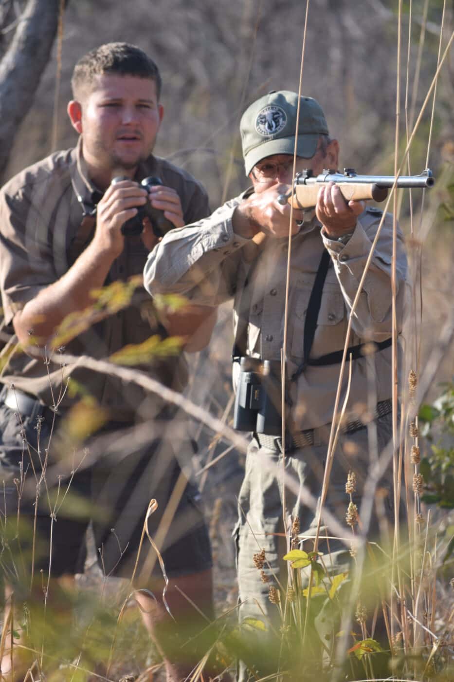 shooting deer in the field while aiming with feet