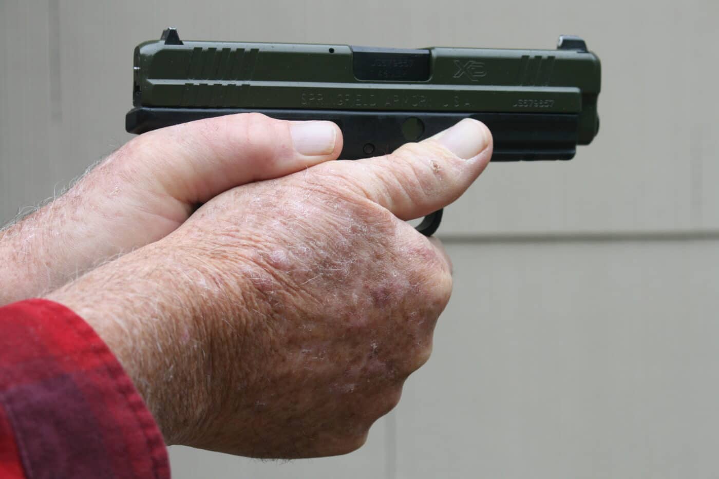 two handed grip on pistol