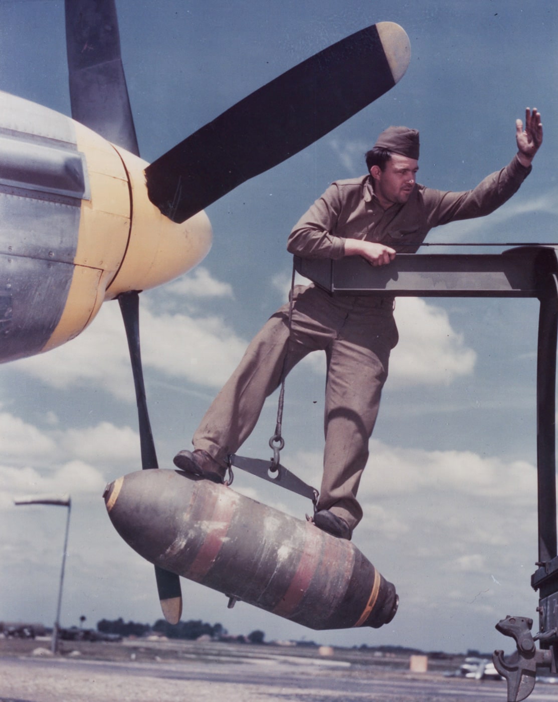 loading a bomb on the p-51