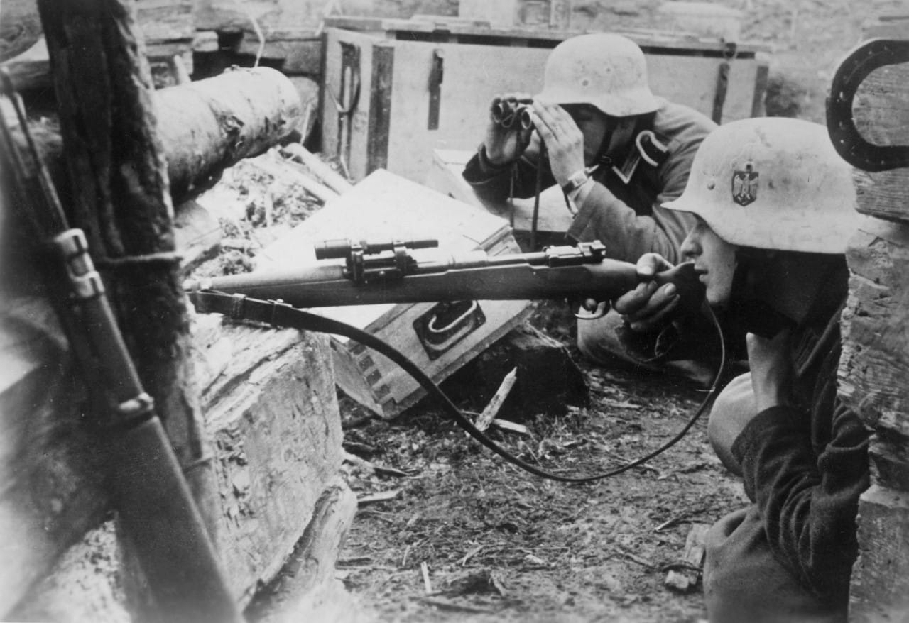 A German sniper team searches for Soviet troops near Lake Ladoga on the Eastern Front, 1943