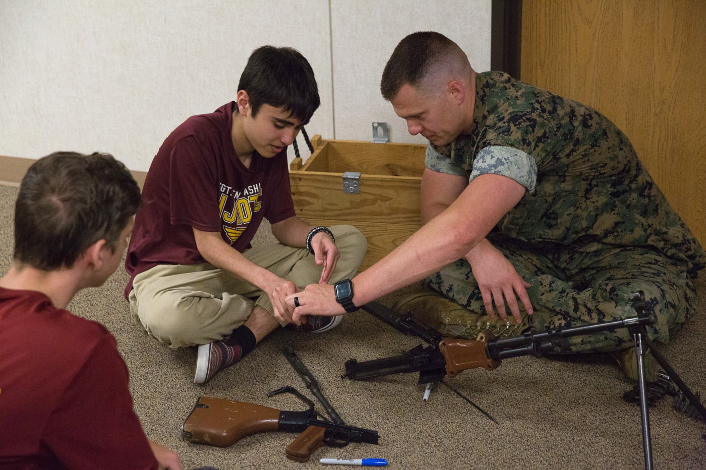 us marine teaching school kid about the rpd machine gun