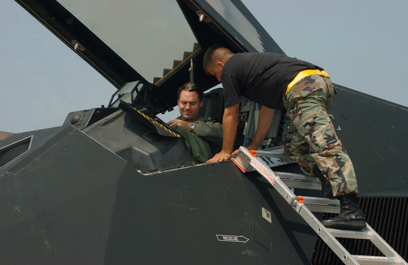 f-117 pilot in the cockpit of plane with crew chief