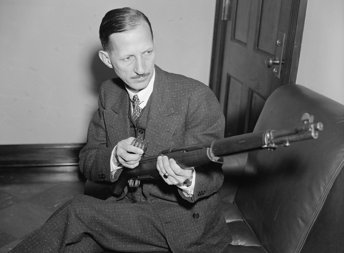 man demonstrating how to load an m1 garand rifle