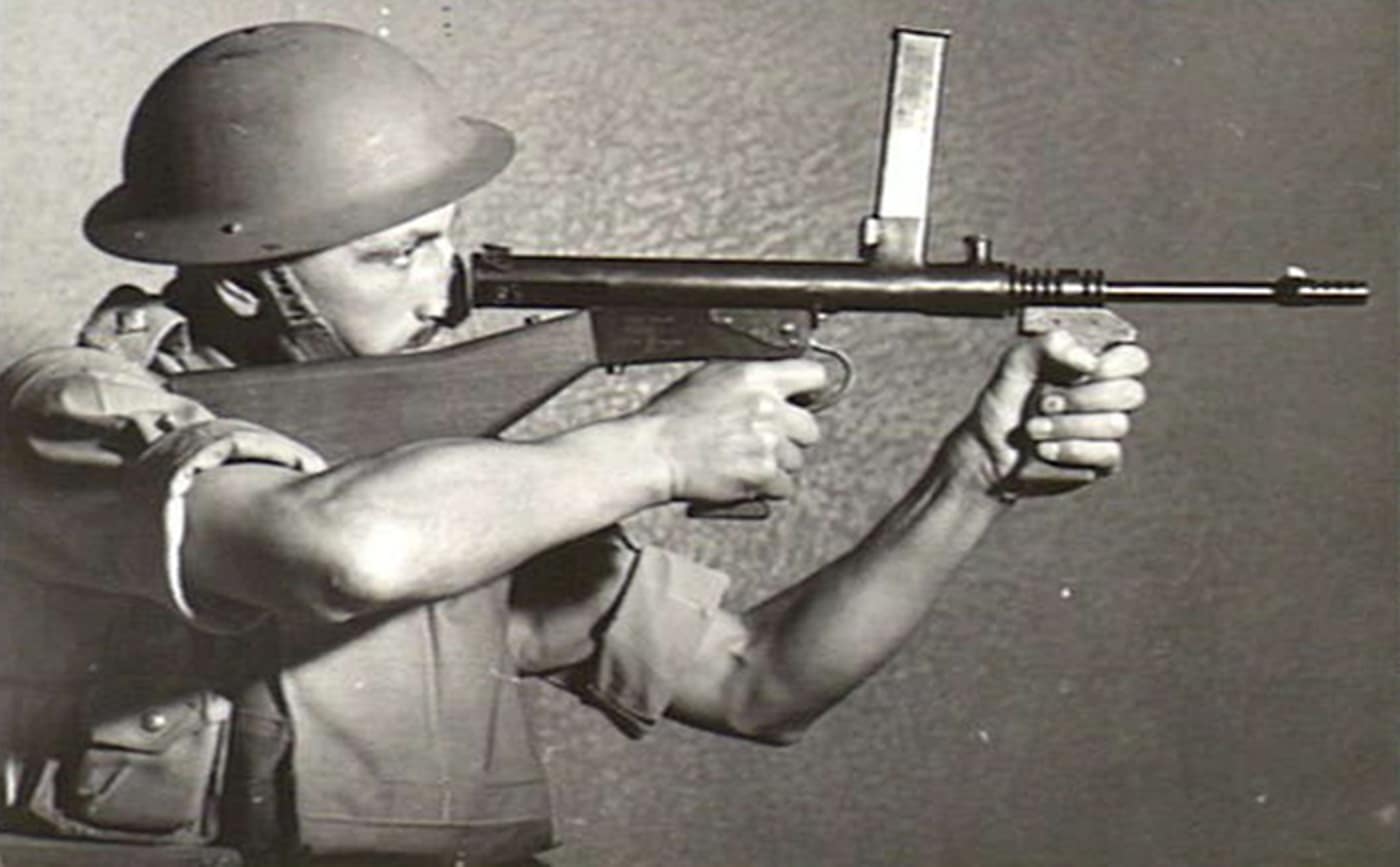 soldier demonstrating aimed fire from owen gun