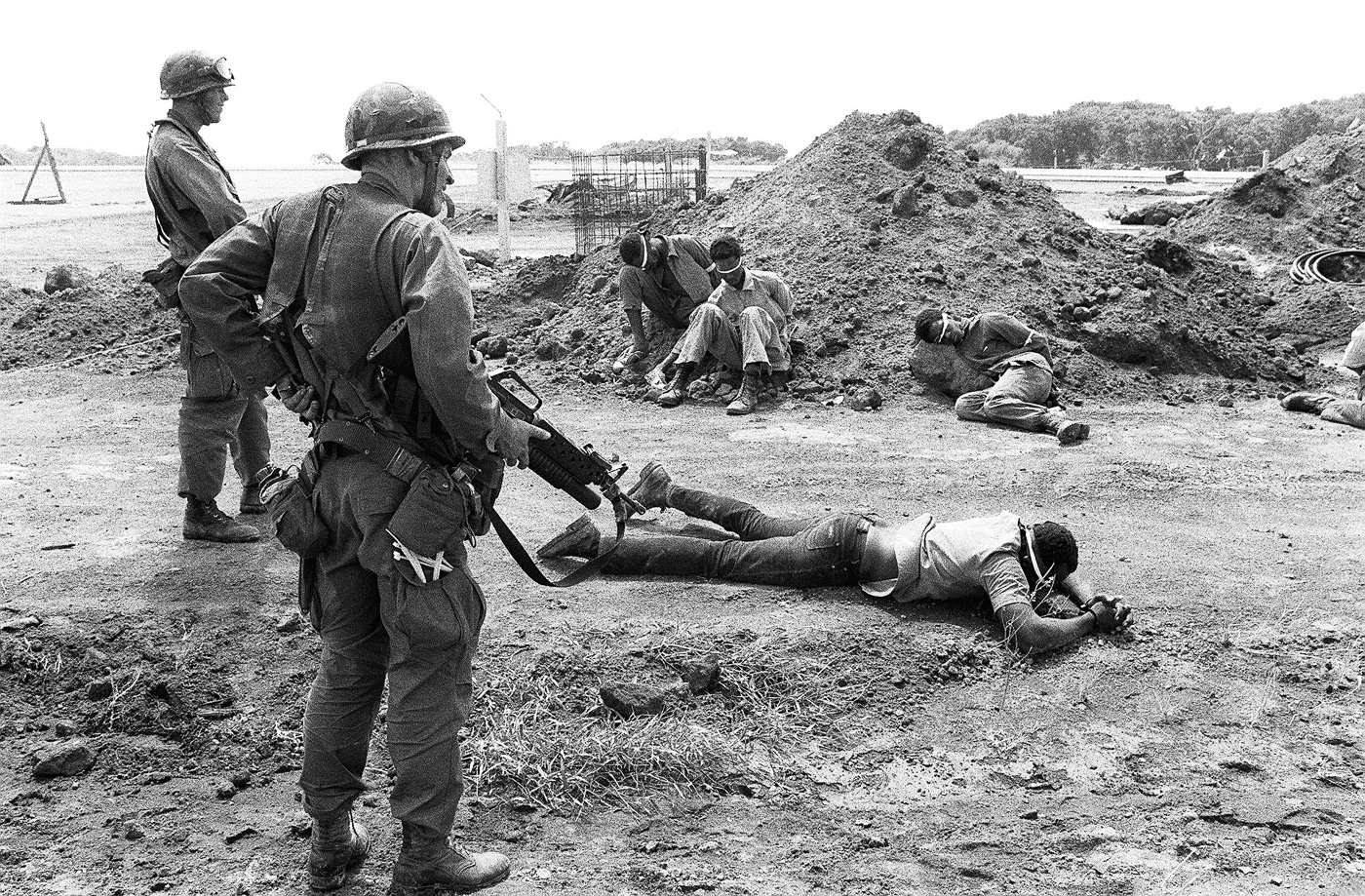 us soldier guarding communist pows in grenada