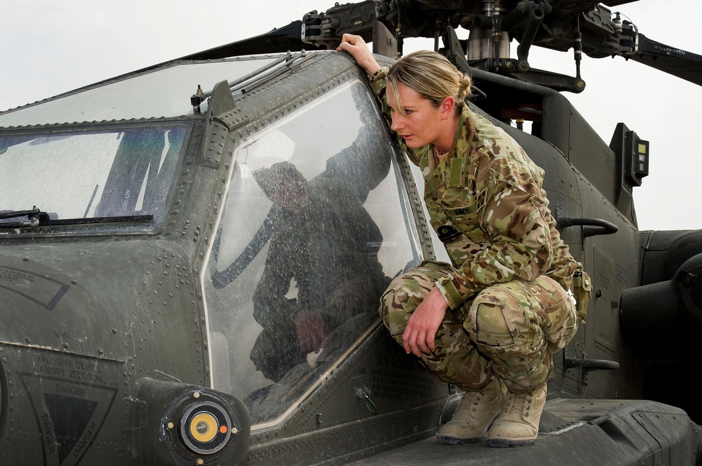 australian navy pilot examines the ah-64 helicopter