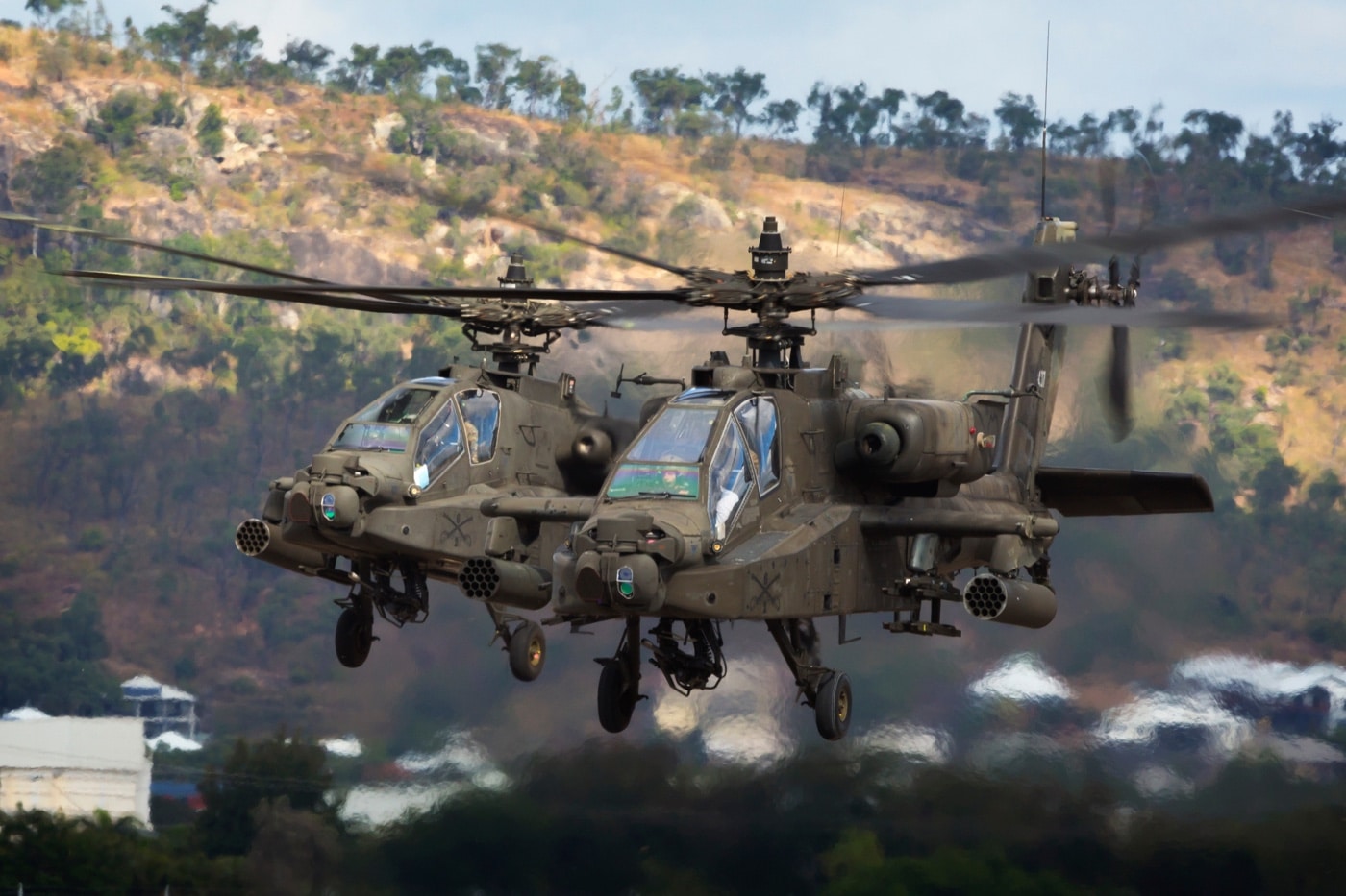 boeing ah-64 apache helicopters in flight