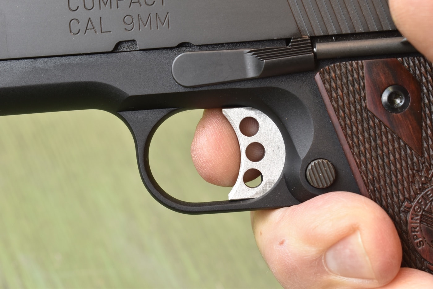 fingertip on the 1911 trigger