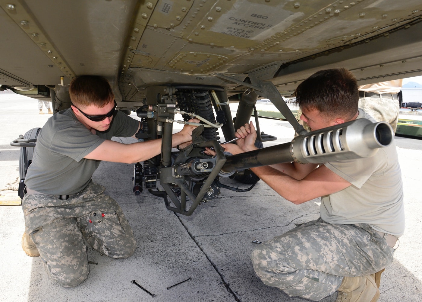 ground team works on m230 30mm chain gun