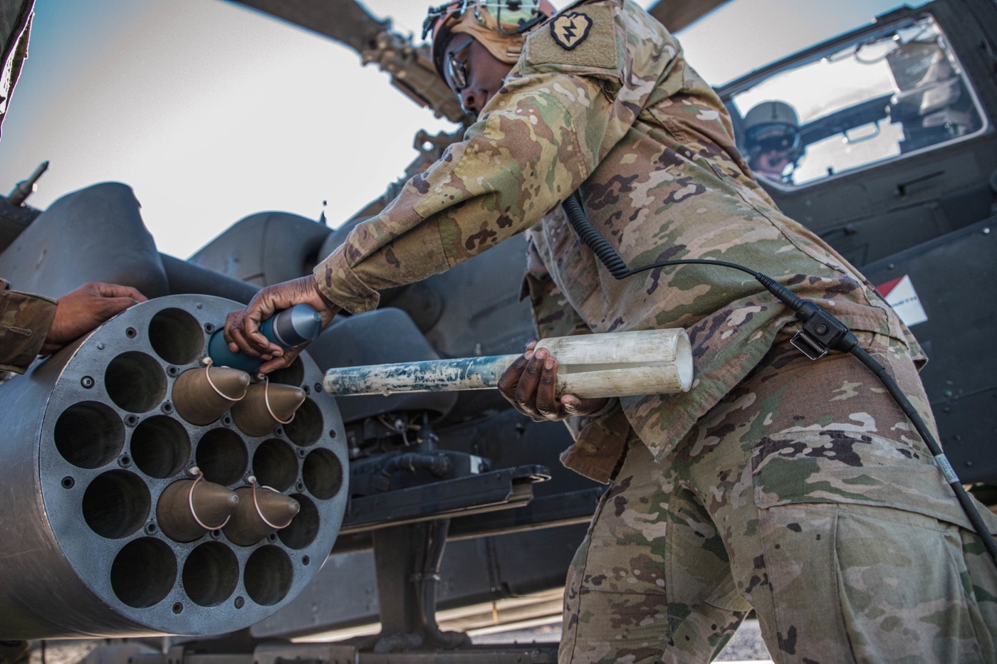 m261 rocket launcher being loaded on ah-64 attack helicopter