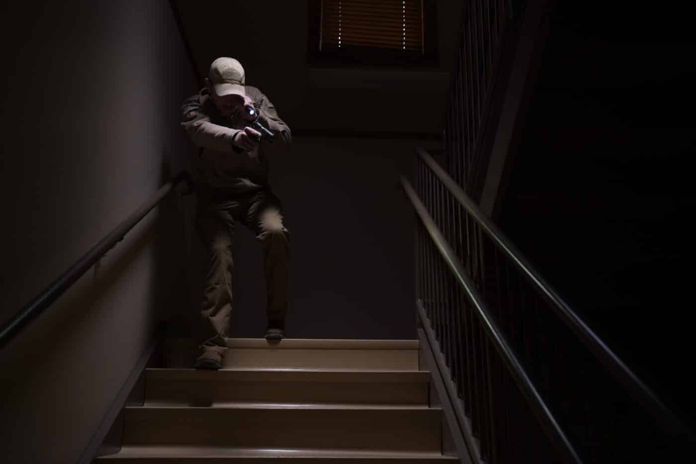 officer with 1911 clearing stairwell