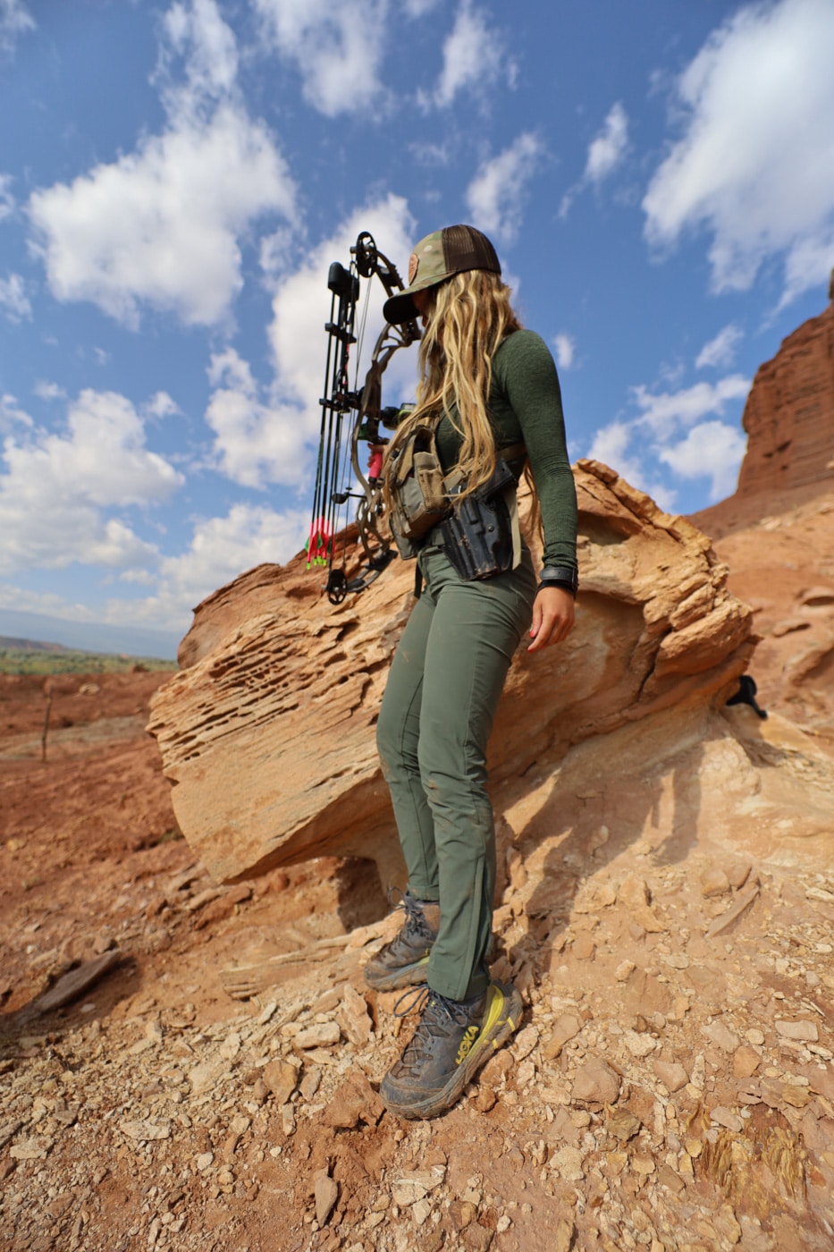 author carrying her 1911 in a owb rig mounted on the waist strap of her pack