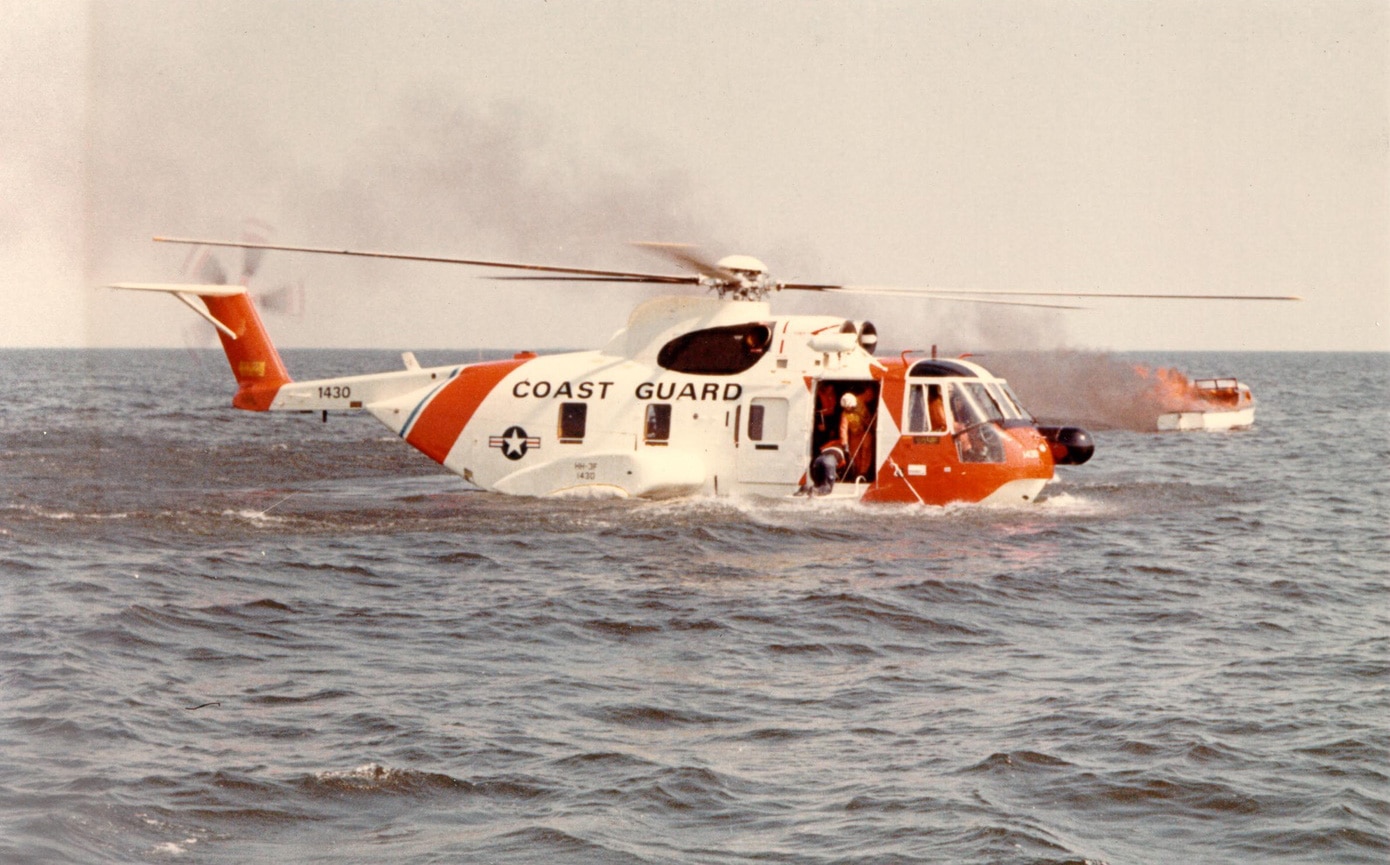 coast guard recue helicopter floating on ocean during boat fire