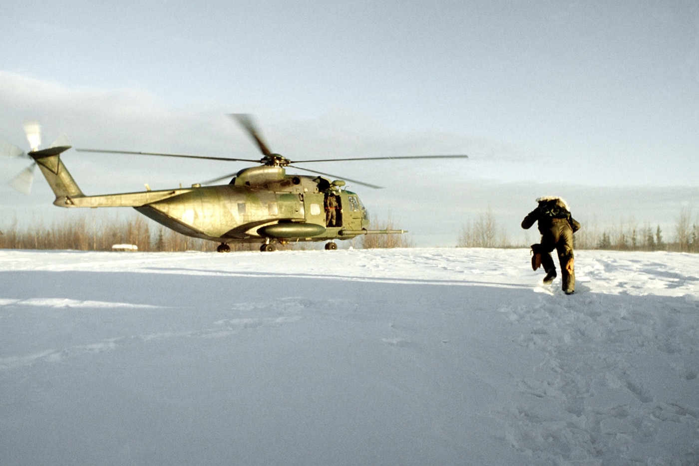 pilot rescued in snow by hh-3e helicopter during a live fire exercise