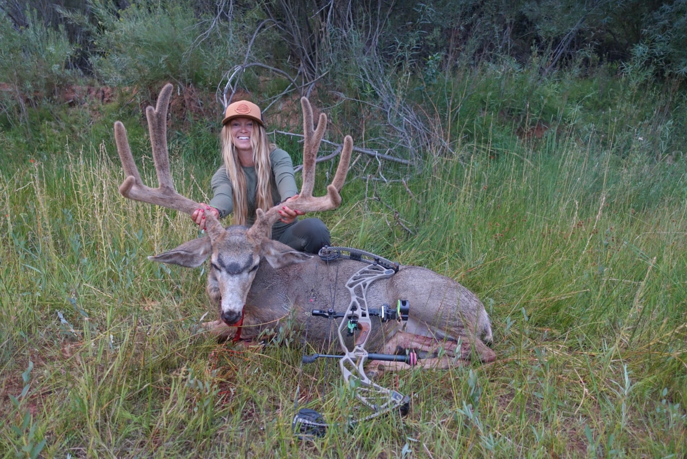 woman bow hunting deer