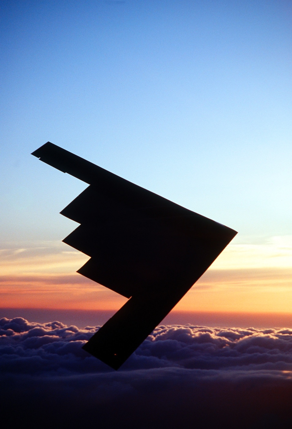 b-2 bomber silhouette during flight at sunset