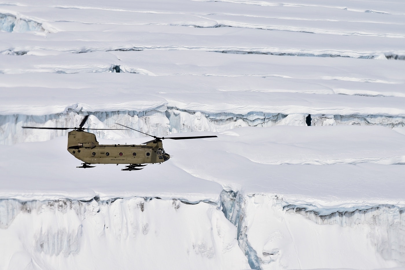 chinook from high altitude rescue team flies the crevices of mt denali