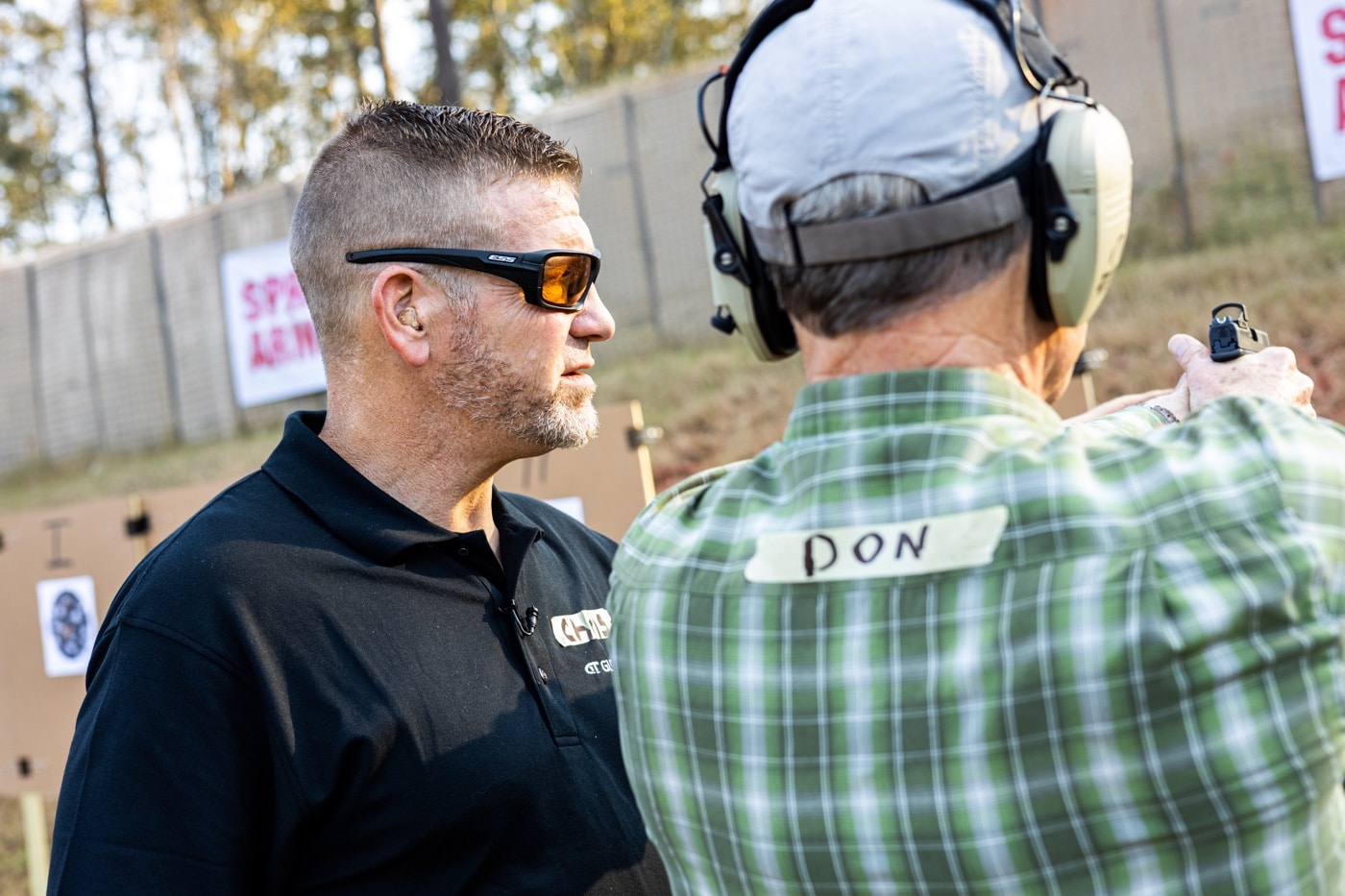 chris cerino working with a shooter on the range