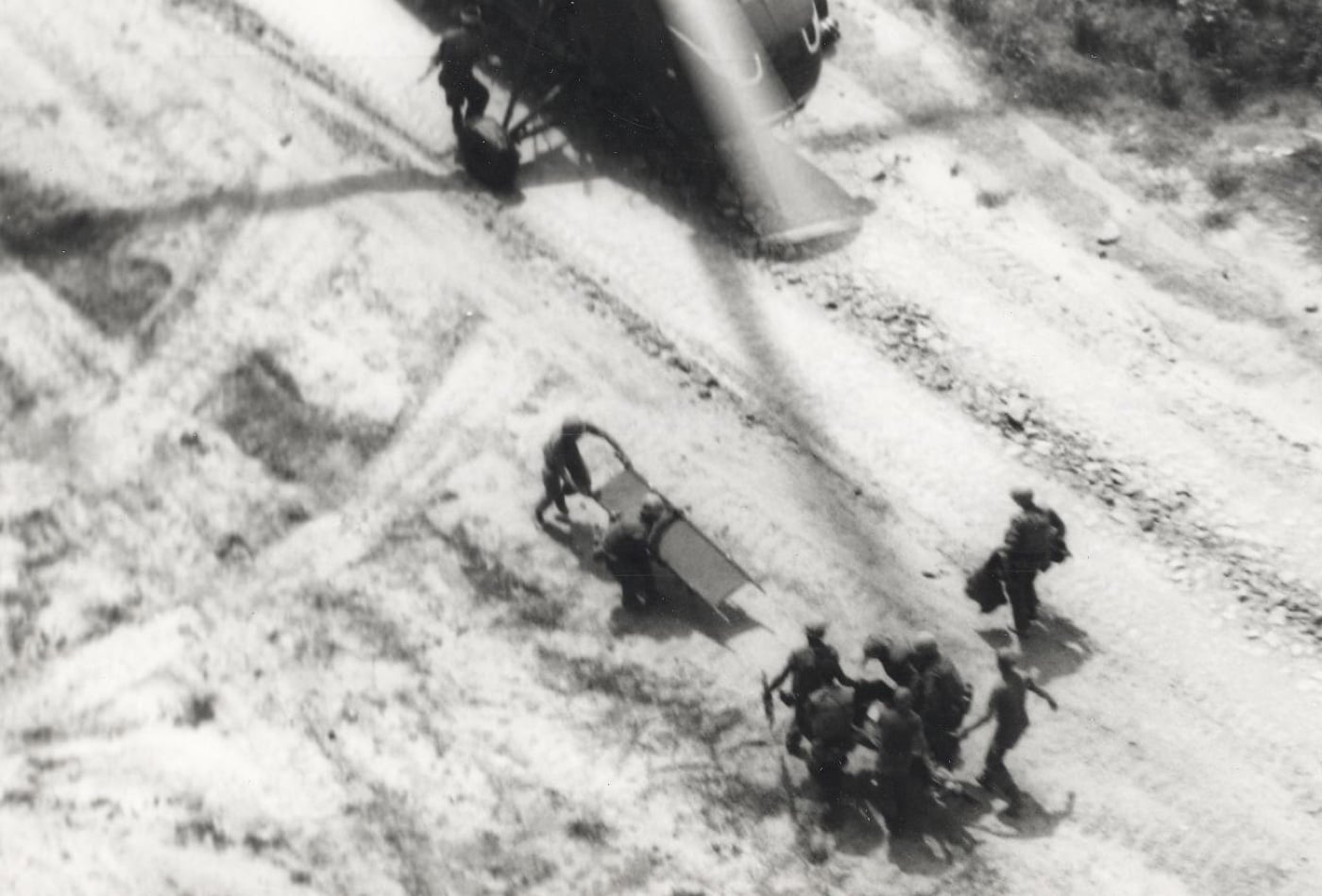 corpsman loads a wounded marine on a helicopter for medical evacuation