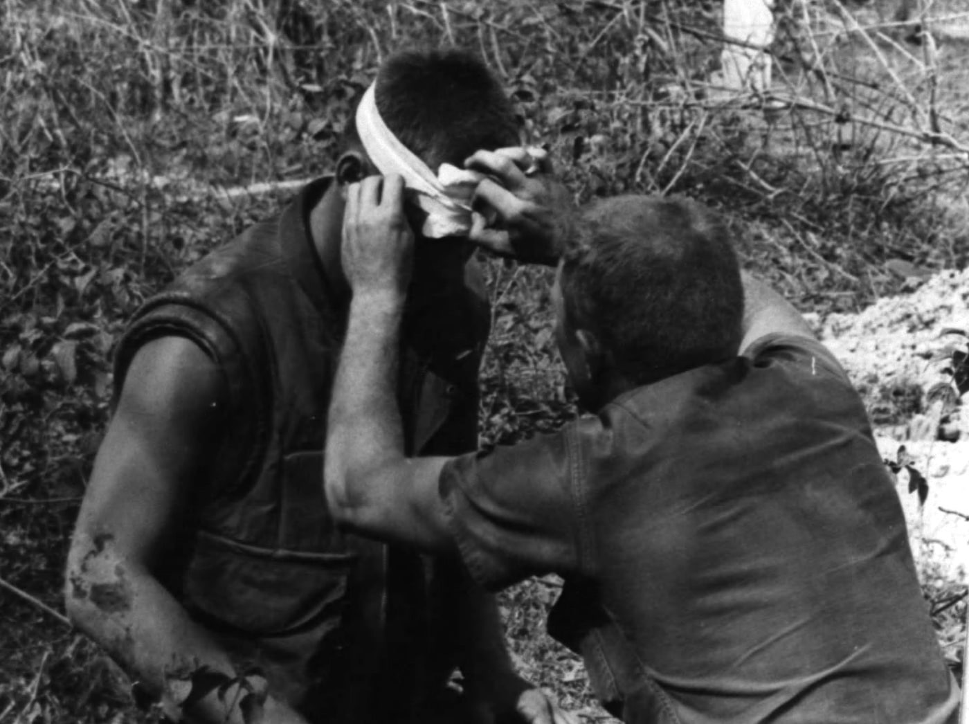 corpsman treats marine with head injury in vietnam