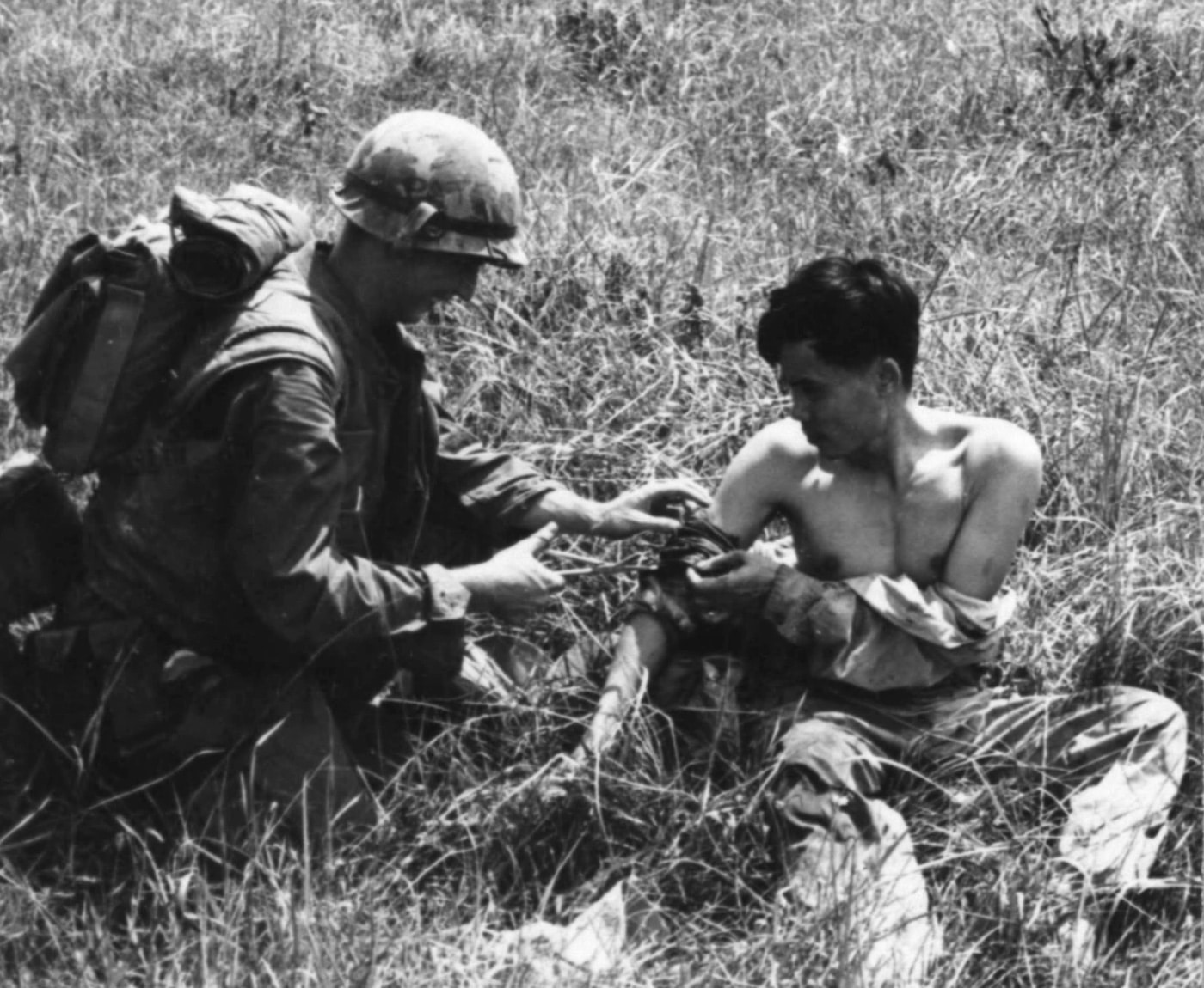 corpsman treats vietnamese soldier with arm injury