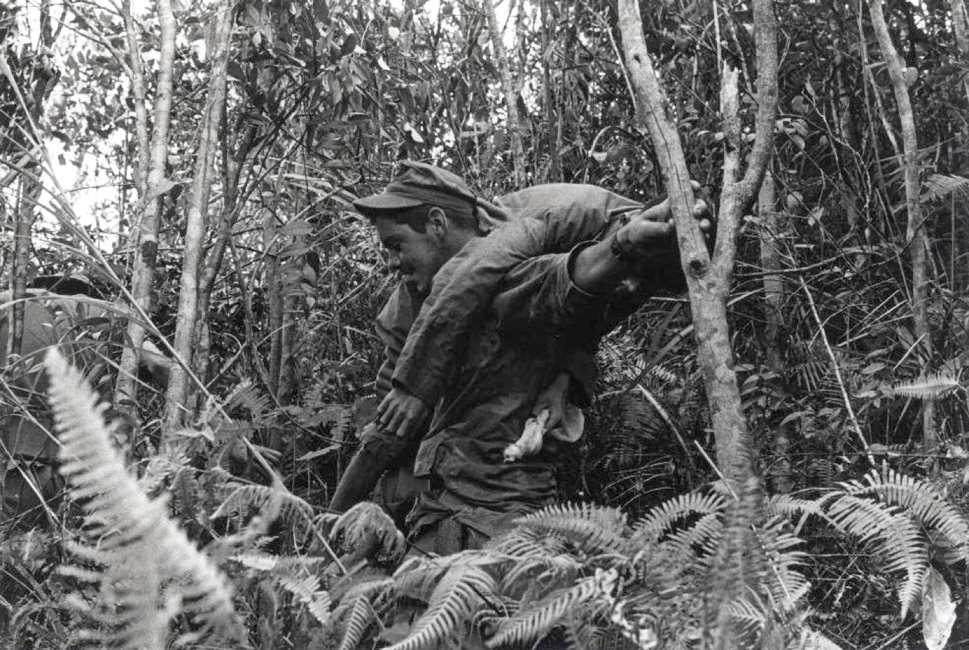 navy corpsman in vietnam carrying wounded soldier