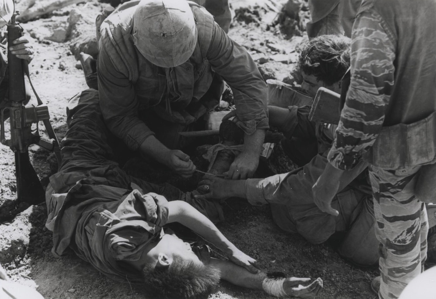 navy corpsman treats a vietnamese soldier