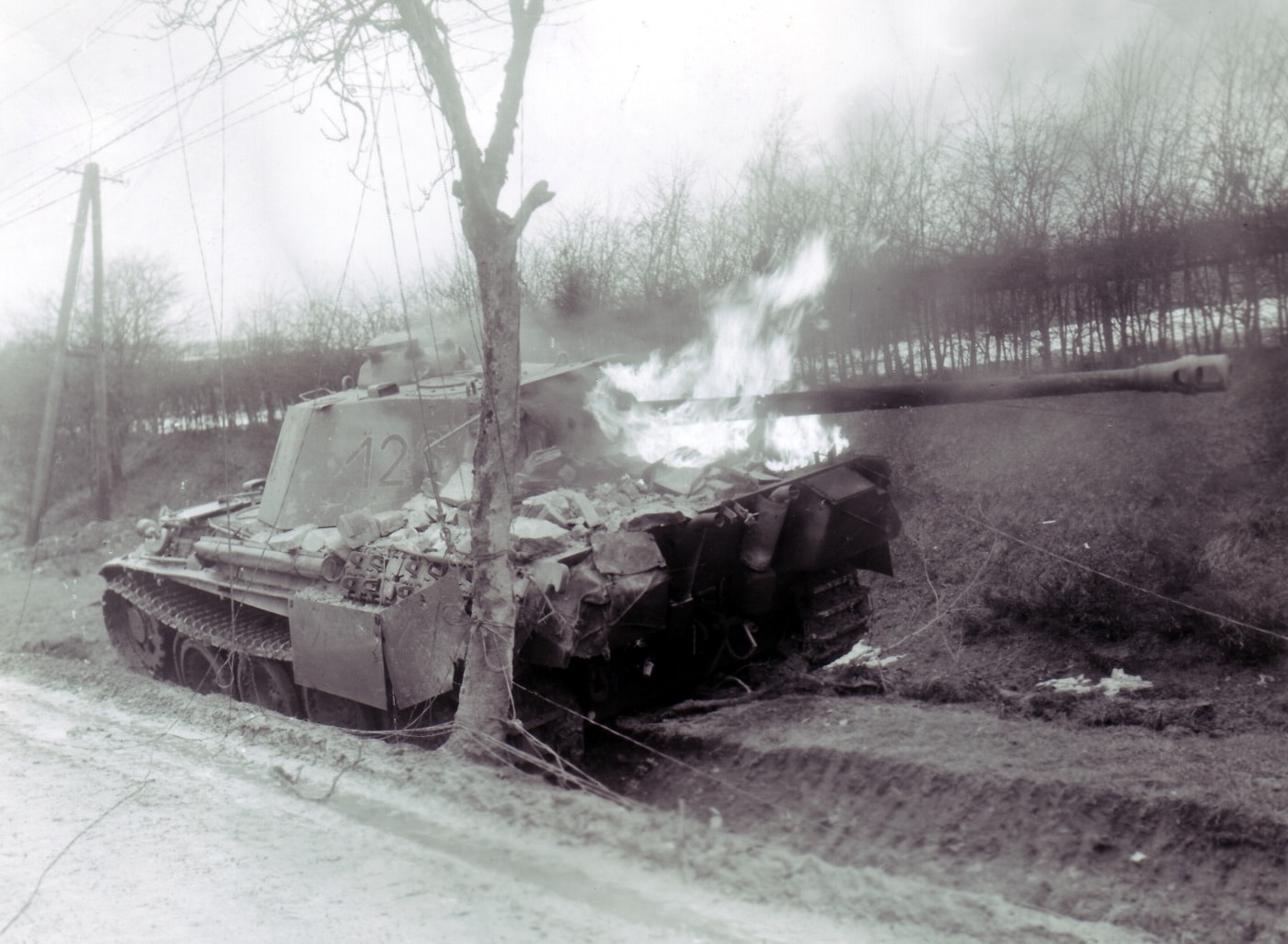 german panther tank burning near bastogne