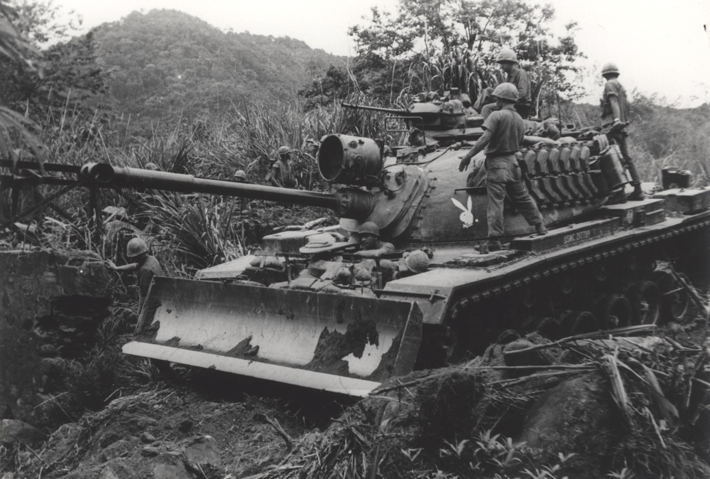m48 tank with bulldozer blade cutting a road in vietnam
