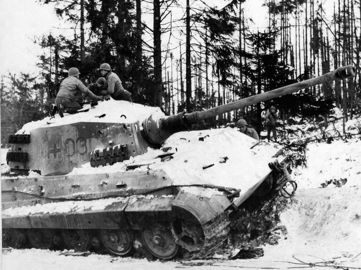 us soldiers examine destroyed king tiger tank near bastogne