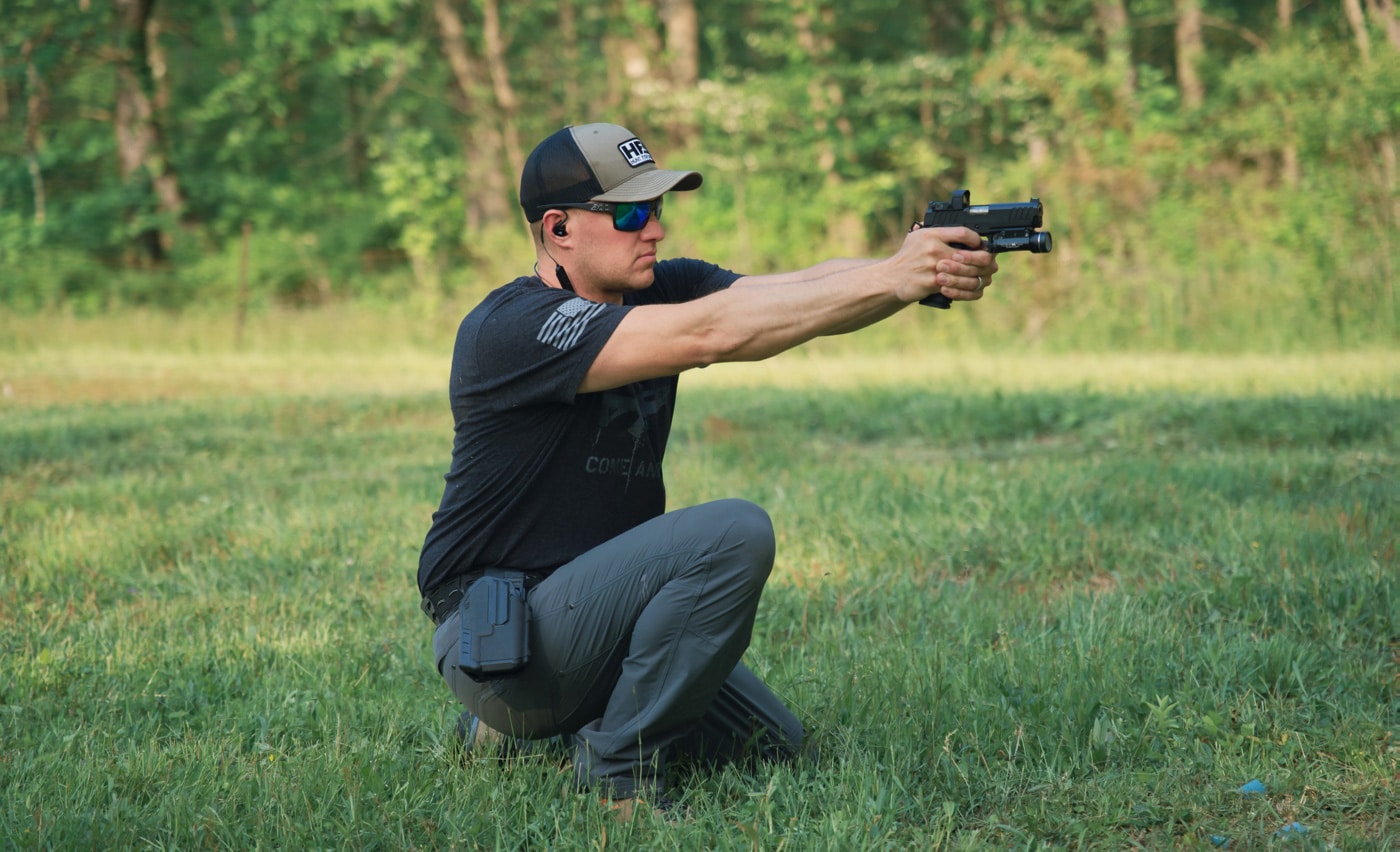 shooting a pistol from a kneeling position