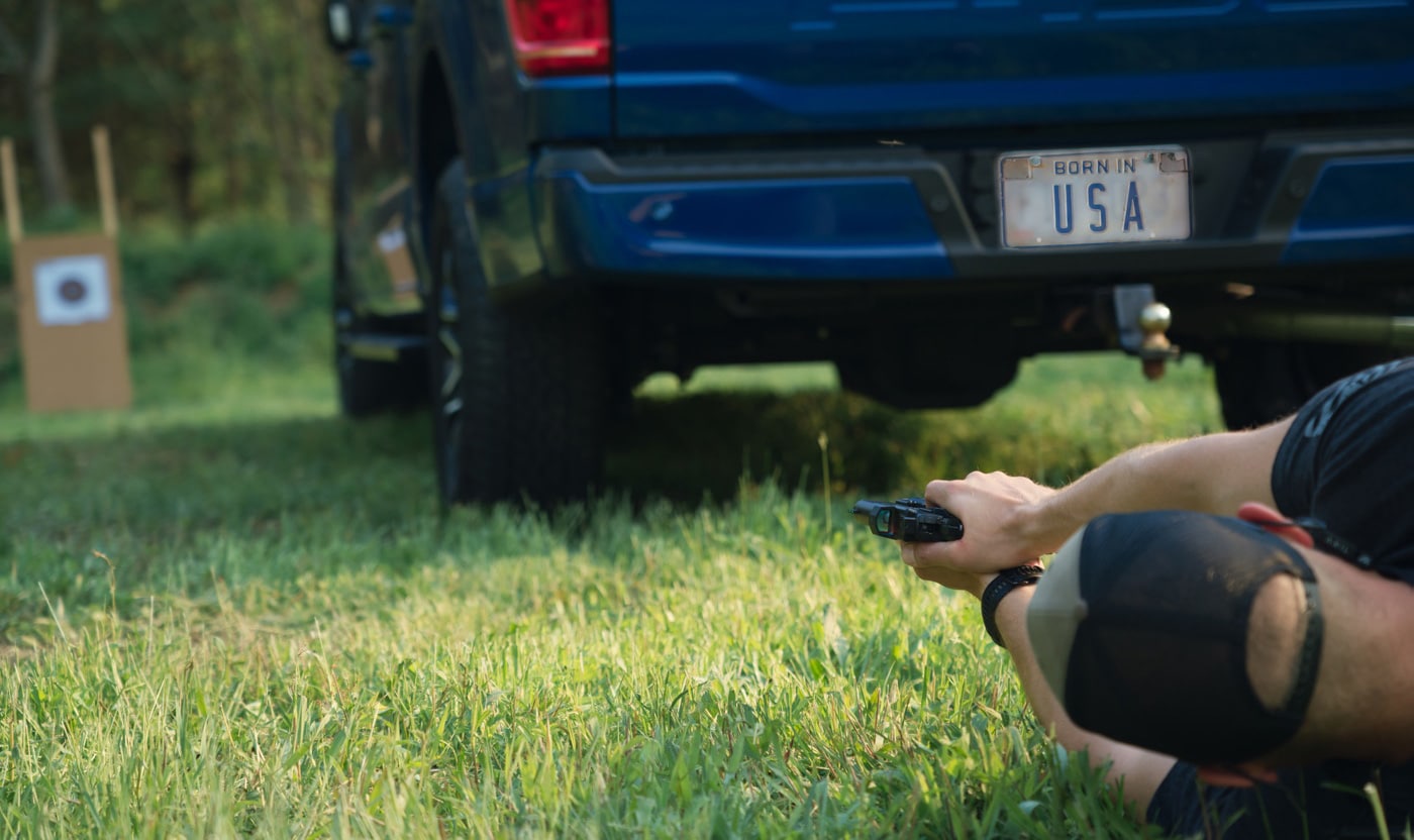 shooting around a truck while laying down