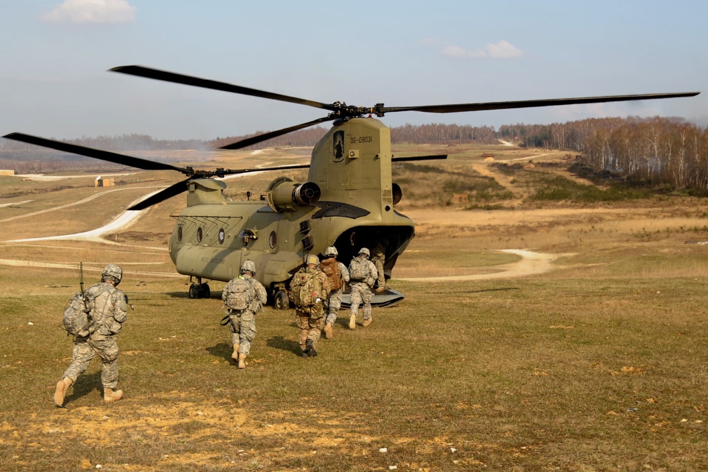 us army paratroopers load into a ch-47 chinook on a nato training mission