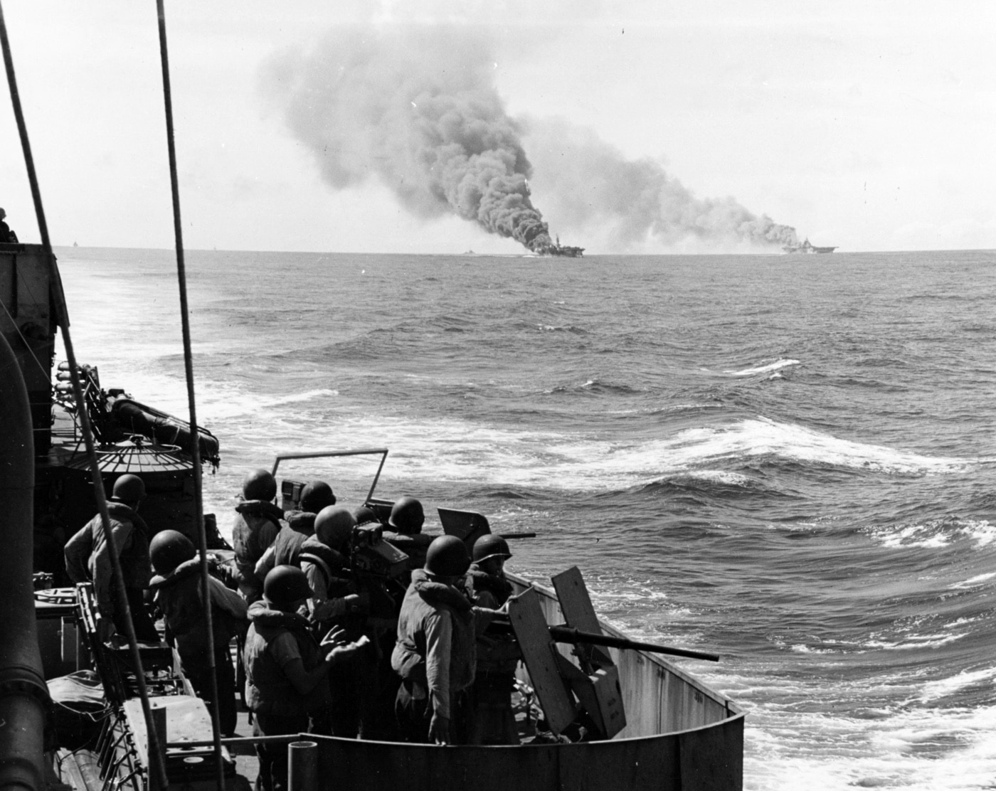 uss belleau wood cvl-24 burns after being hit by a kamikaze plane