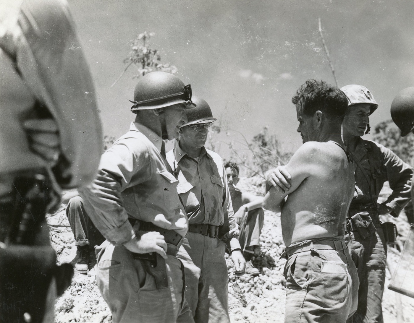 admiral cochrane talks to shirtless col lewis chesty puller on peleliu