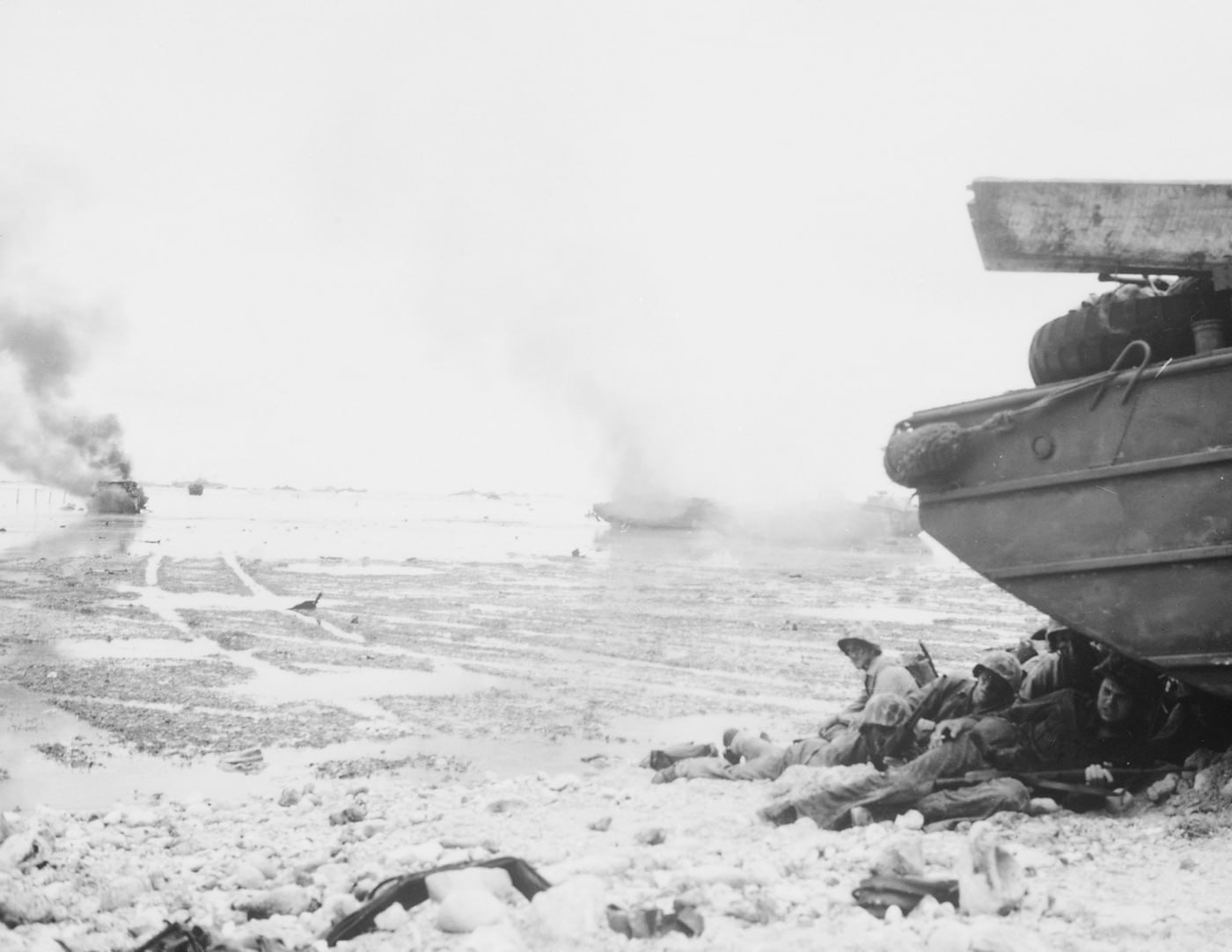 marines take cover behind a dukw on peleliu