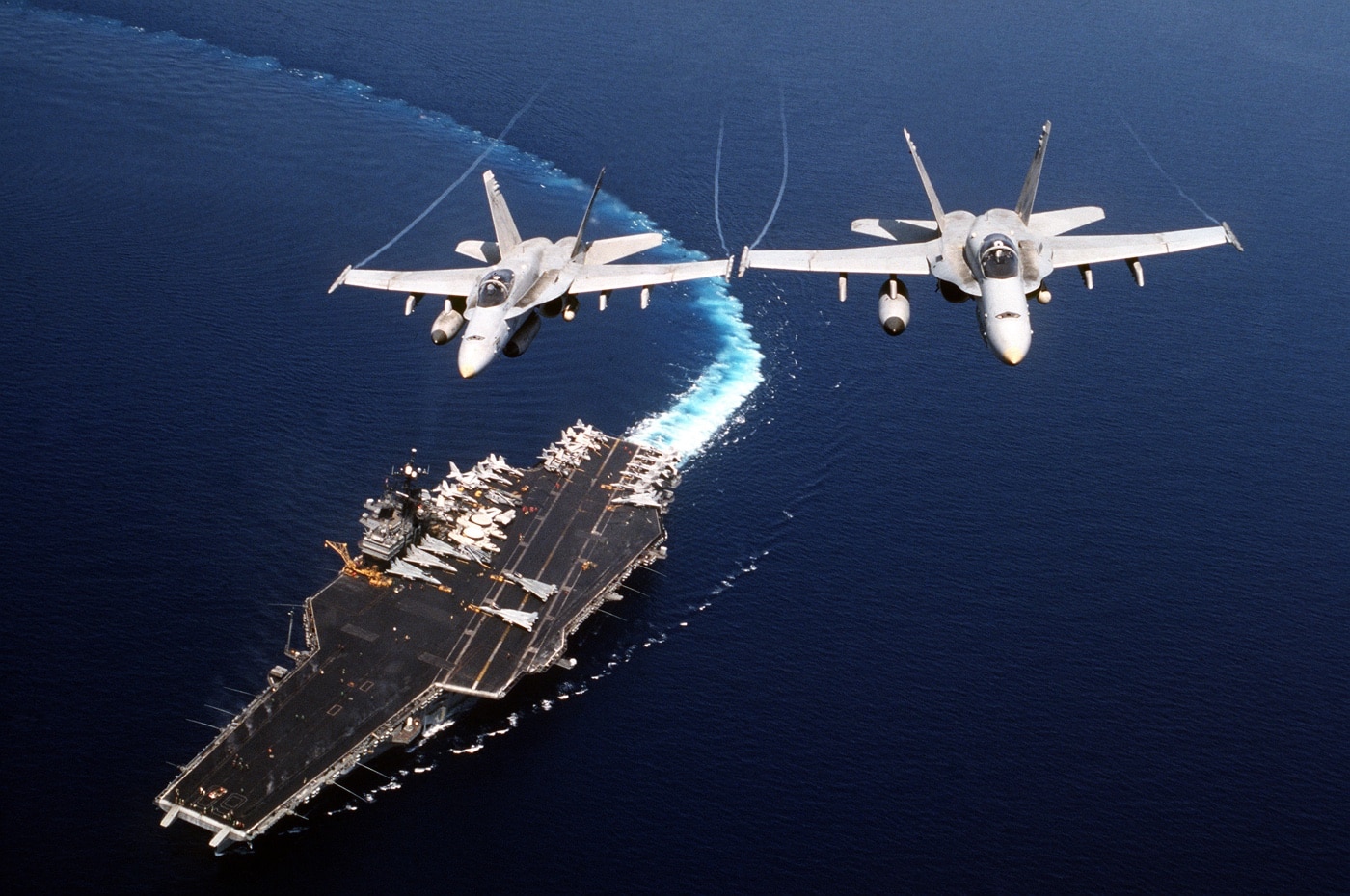 two f-18 fly over uss saratoga